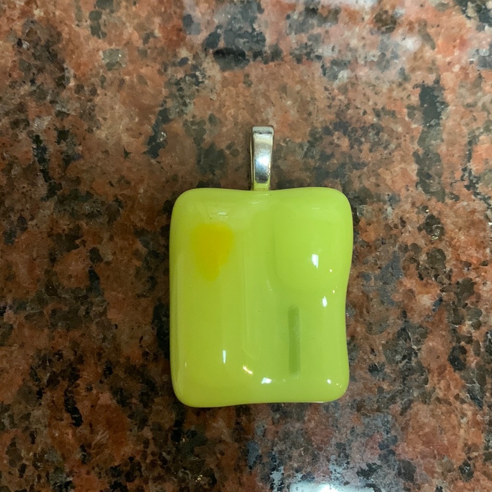 Unique lime color pendant with silver hook .